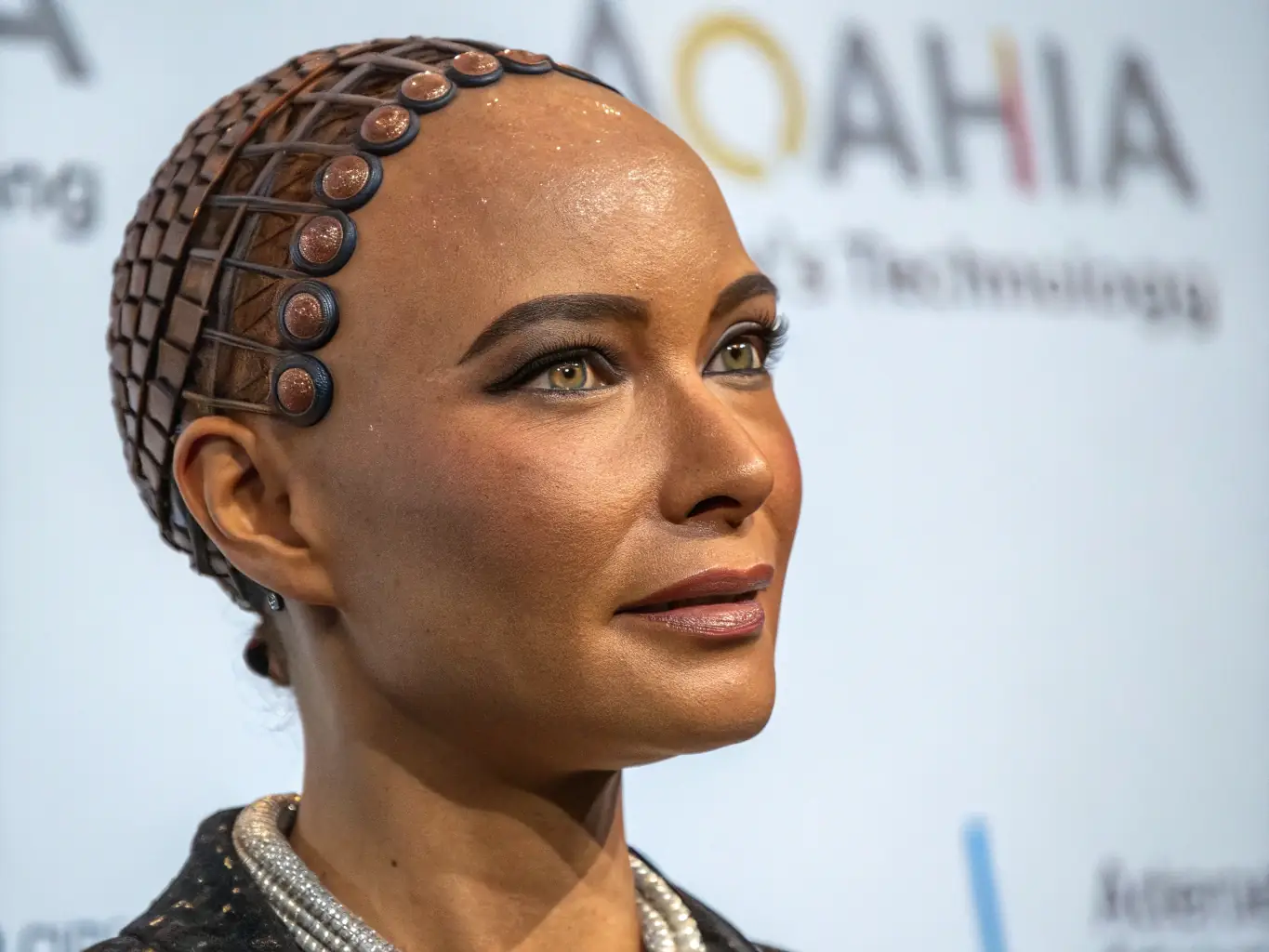 A hyper-realistic digital avatar blinking and subtly reacting to cursor movements on a website, showcasing its interactive nature.